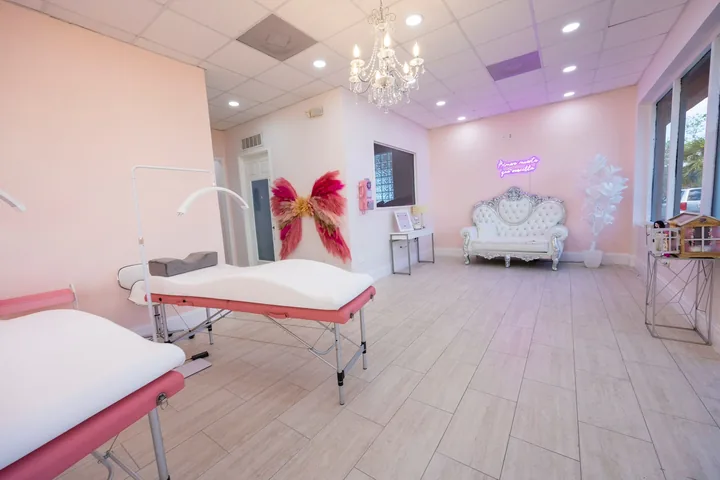 Blush interior with chandeliers and butterfly art