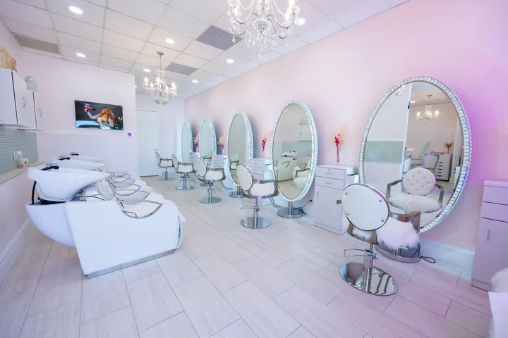 Styling stations with oval mirrors at The Beauties Salon