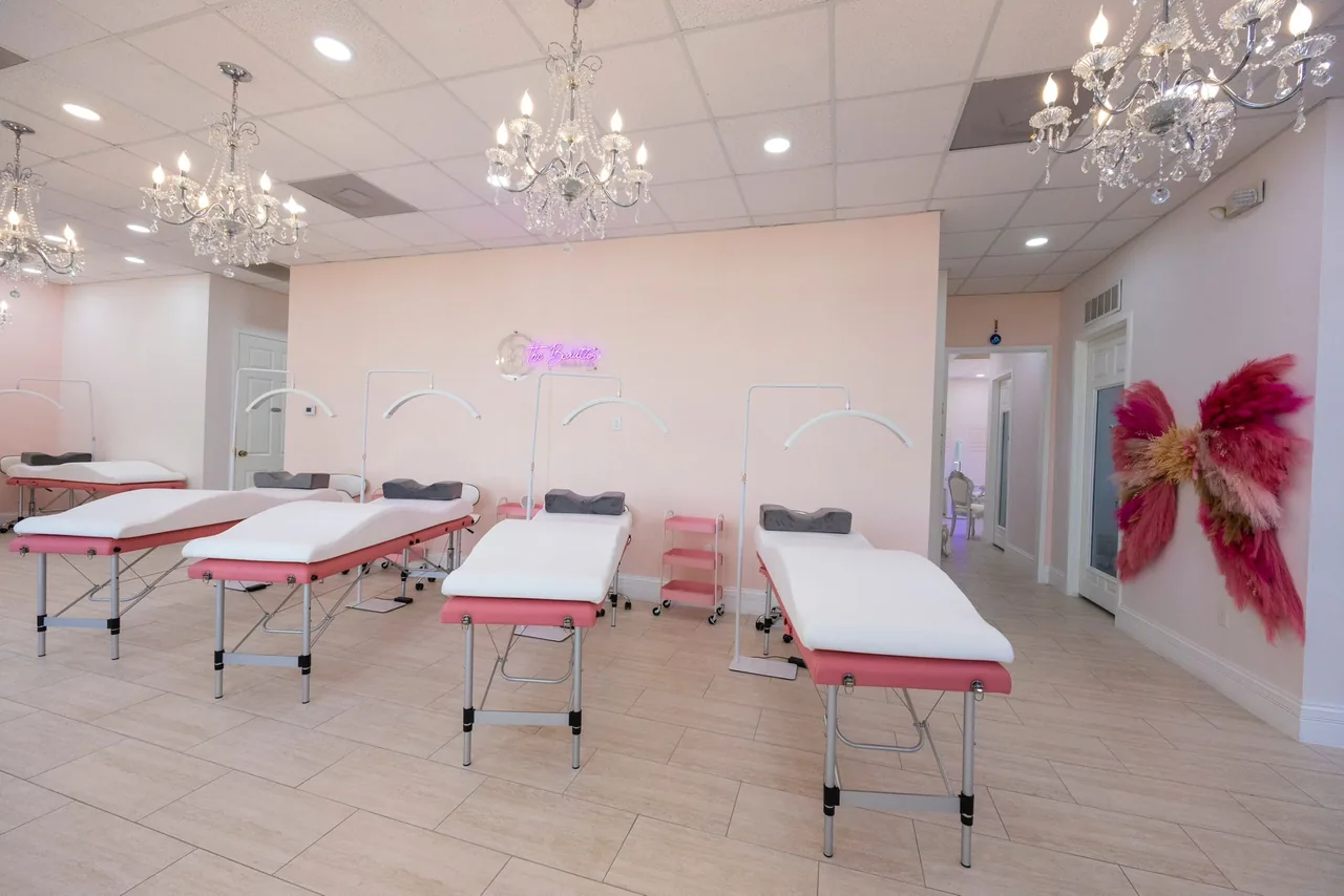 Row of treatment beds beneath chandeliers