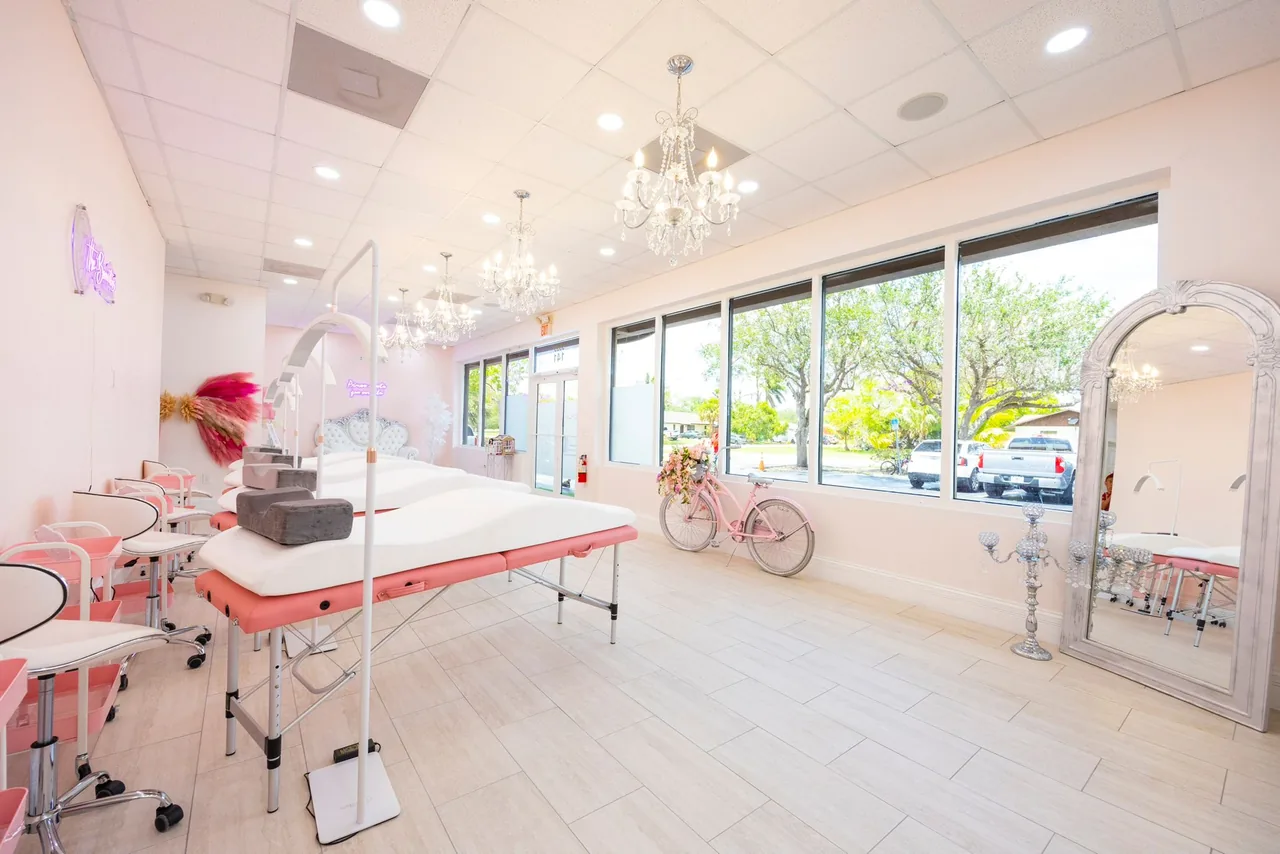 Light-filled salon with windows and treatment beds