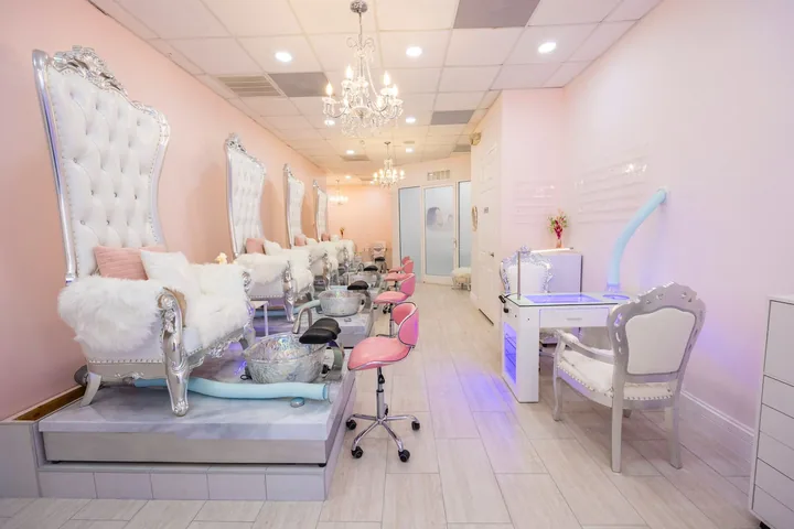 Ornate pedicure thrones under a chandelier at The Beauties Salon