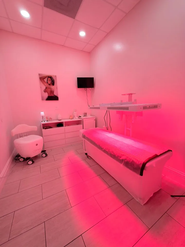 Treatment bed under pink neon glow